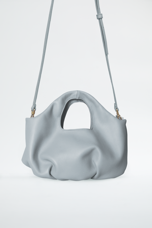 
                  
                    Pillow handbags with pleats in the base. Grey dolphin color and removable long strap. Soft draped bag by Blame Lilac 
                  
                