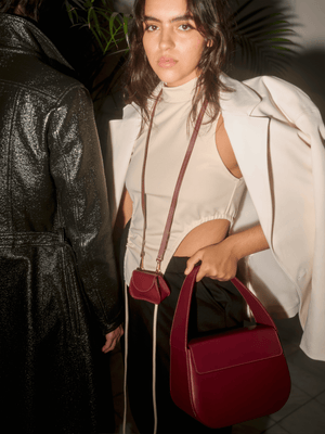 
                  
                    Burgundy cesta handbag with off-white stitching, by Blame Lilac 
                  
                